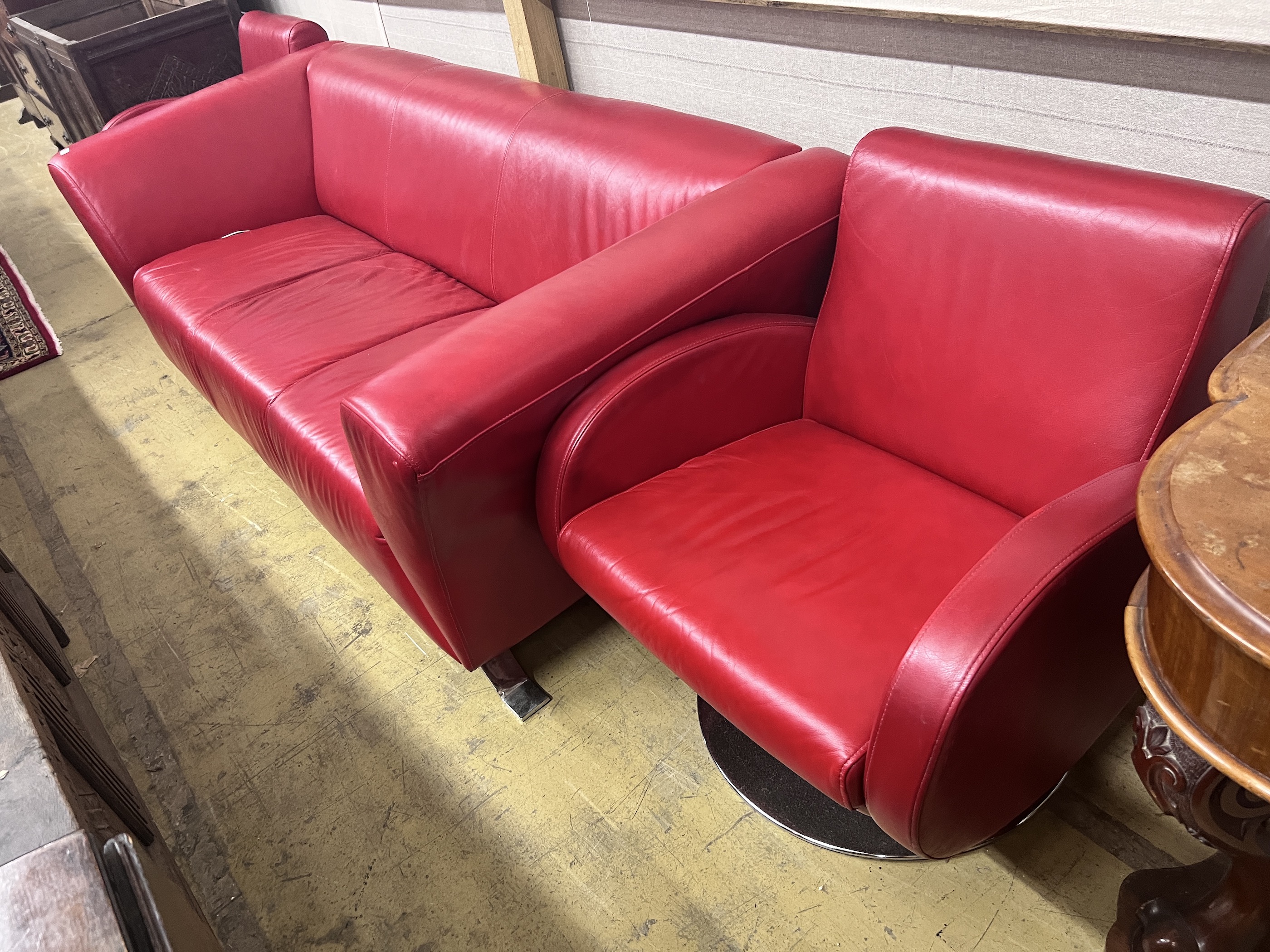 A contemporary leather three seater settee, length 204cm, width 86cm, height 70cm and two similar swivel armchairs on chrome bases